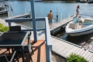 Boat mooret at private jetty in front of Captains Cove Waterfront Apartments