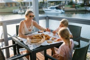 Guests dining on deck at Captains Cove Waterfront Apartments