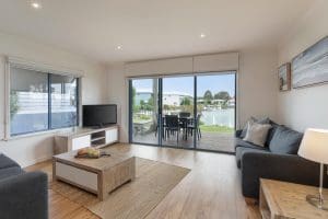 Living area and balcony - Captains Cove Waterfront Apartment