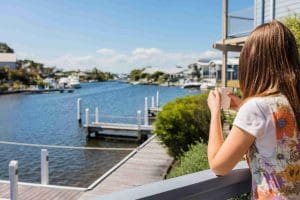 Woman at Captains Cove Waterfront Apartment looking out across the jetty